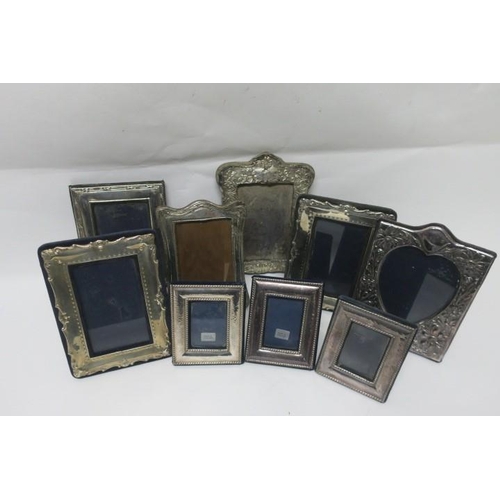 508 - A COLLECTION OF NINE SILVER EMBOSSED PHOTO FRAMES