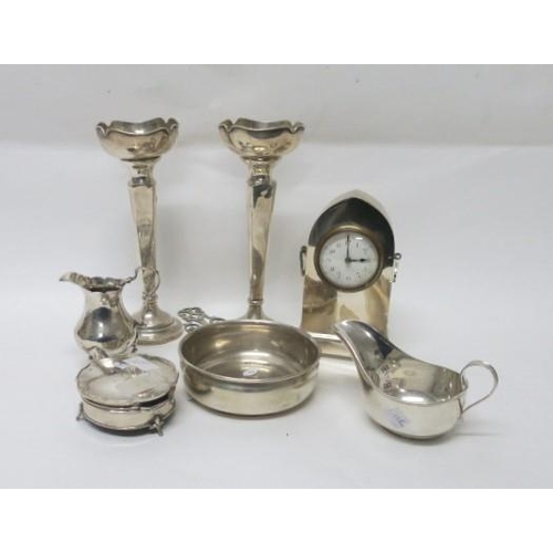 511 - A COLLECTION OF SILVER to include a pair of vases, a sauceboat, a silver case clock, a cream jug, et... 