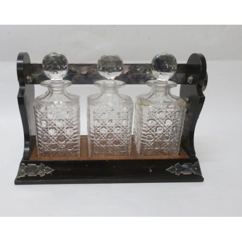 514 - A COROMANDEL WOOD SILVER PLATED AND SILVER MOUNTED TANTALUS London 1968 containing three cut glass d... 