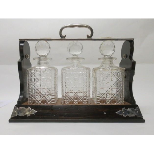 514 - A COROMANDEL WOOD SILVER PLATED AND SILVER MOUNTED TANTALUS London 1968 containing three cut glass d... 