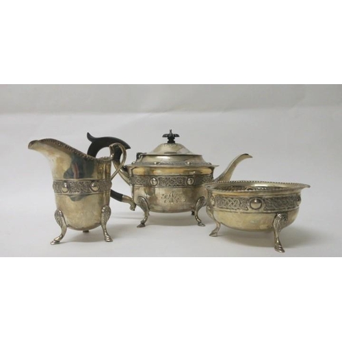 524 - A THREE PIECE IRISH SILVER CELTIC PATTERN TEA SET comprising teapot, sugar bowl and jug Dublin 1922
... 