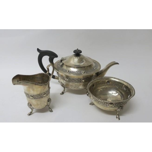 524 - A THREE PIECE IRISH SILVER CELTIC PATTERN TEA SET comprising teapot, sugar bowl and jug Dublin 1922
... 