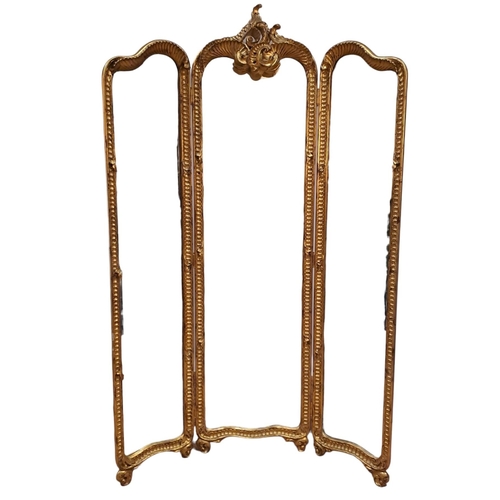 61 - **WITHDRAWN** A CONTINENTAL GILTWOOD TRIPTYCH FOLDING DRESSING MIRROR the rectangular arched bevelle... 