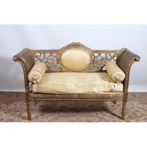 62 - **WITHDRAWN** A CONTINENTAL GILTWOOD UPHOLSTERED AND CANED SETTEE the reeded top rail centred by an ... 