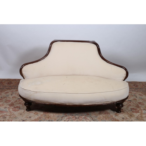 651 - AN EDWARDIAN MAHOGANY AND UPHOLSTERED SETTEE the shaped frame with upholstered back and seat on reed... 