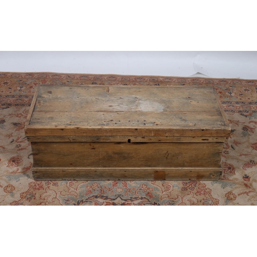 653 - A VINTAGE PINE TRUNK of rectangular outline with hinged lid and moulded apron on platform support 
3... 