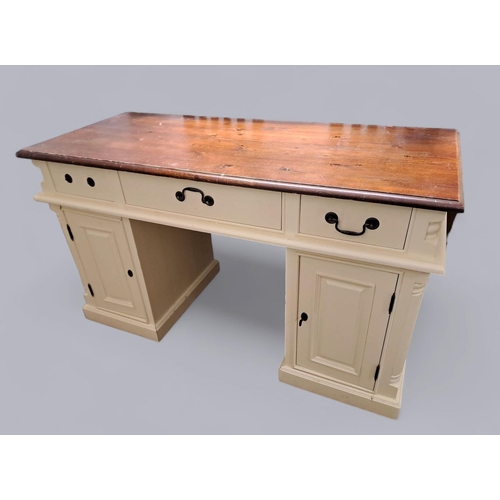 709 - A CREAM PAINTED AND PINE DESK of rectangular outline the shaped top above three frieze drawers and c... 