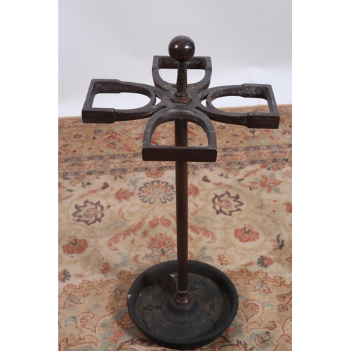 81 - **WITHDRAWN** A BRONZED FOUR SECTIONAL STICK STAND the stirrup shaped compartments above a cylindric... 