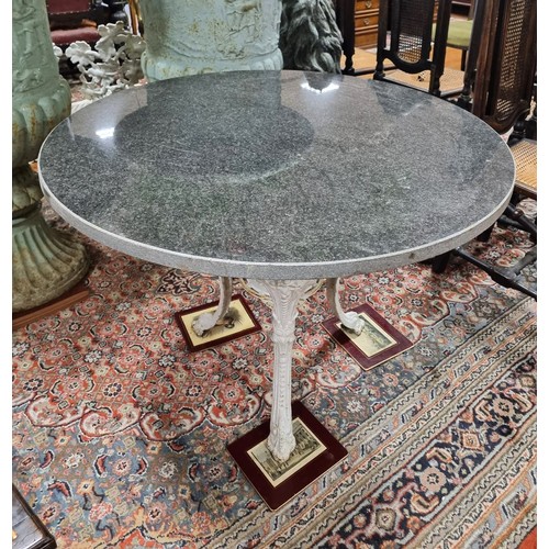 380 - A 19TH CENTURY CAST IRON PATIO TABLE surmounted by a black veined marble top raised on figural mask ... 