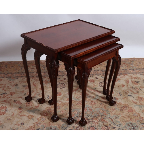 78 - A NEST OF THREE MAHOGANY TABLES each of rectangular outline with moulded gallery on cabriole legs wi... 