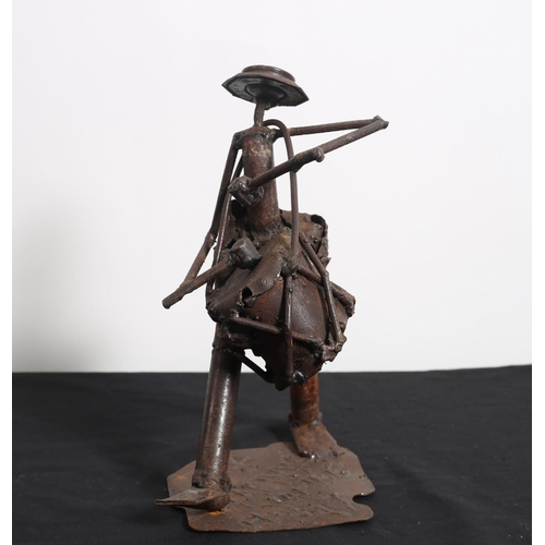 455 - A CAST METAL FIGURE modelled as a drummer shown standing on a shaped platform base
27cm (h)