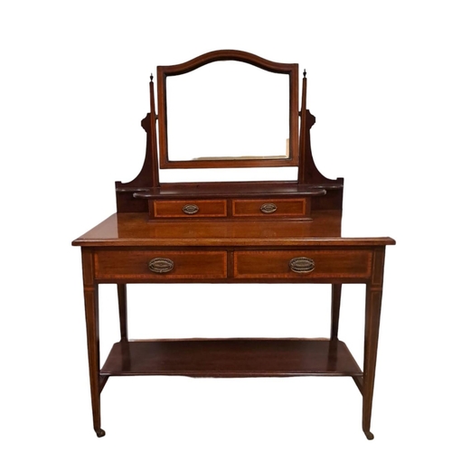 30 - AN EDWARDIAN MAHOGANY AND SATINWOOD CROSSBANDED DRESSING TABLE the bevelled glass swivel mirror abov... 