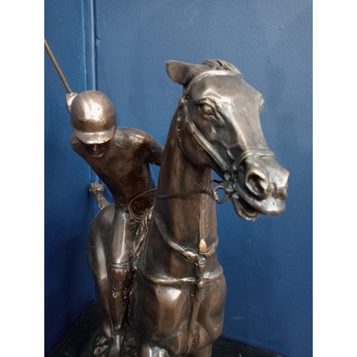 382 - A BRONZE STATUE modelled as a polo player on horseback shown on a naturalistic base with marble plin... 