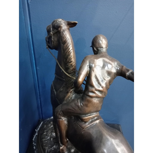 382 - A BRONZE STATUE modelled as a polo player on horseback shown on a naturalistic base with marble plin... 