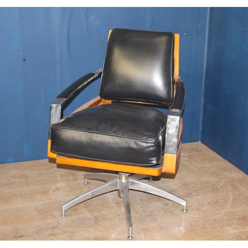 384 - A DESIGNER TEAK CHROME AND BLACK LEATHER UPHOLSTERED SWIVEL CHAIR the shaped upholstered back and se... 