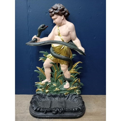 389 - A 19TH CENTURY CAST IRON AND PAINTED STICK STAND modelled as young Hercules shown standing holding a... 