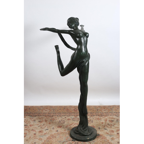 397 - A BRONZE FIGURE modelled as a semi clad female shown standing on one leg with outstretched arms rais... 
