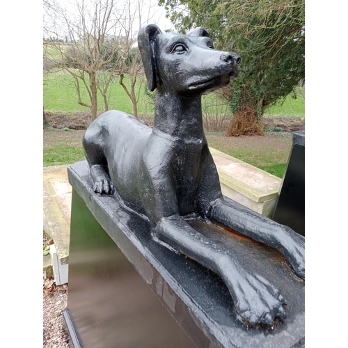 407 - A FINE PAIR OF CAST IRON FIGURES each modelled as a hound shown recumbent raised on a rectangular sp... 