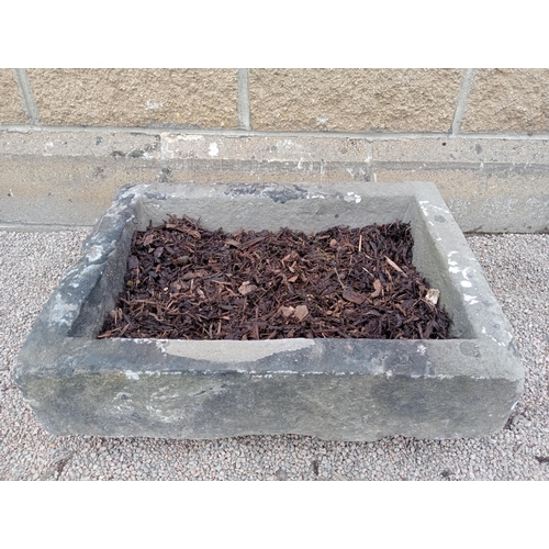 412 - A 19TH CENTURY LIMESTONE TROUGH of rectangular outline 
19cm (h) x 61cm (w) x 46cm (d)