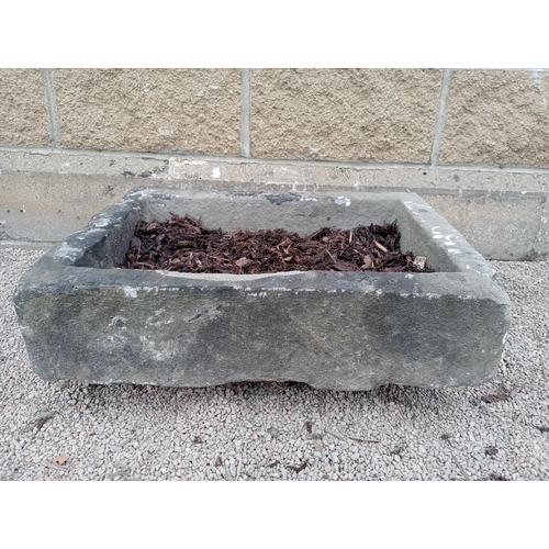 412 - A 19TH CENTURY LIMESTONE TROUGH of rectangular outline 
19cm (h) x 61cm (w) x 46cm (d)