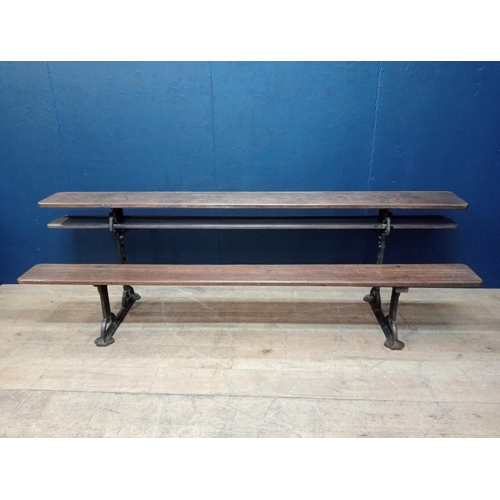 420 - A VINTAGE CAST IRON AND PINE GARDEN BENCH the rectangular planked back and seat raised on a cast iro... 