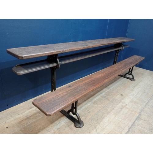 420 - A VINTAGE CAST IRON AND PINE GARDEN BENCH the rectangular planked back and seat raised on a cast iro... 