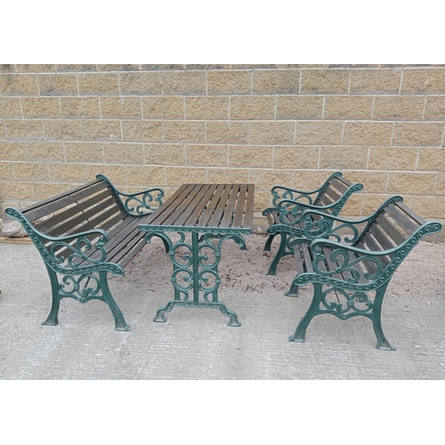 426 - A FOUR PIECE CAST IRON AND PINE PATIO SUITE comprising a pair of elbow chairs each with a slatted ba... 