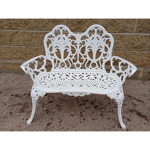 427 - A CAST ALUMINIUM DOUBLE CHAIR BACK GARDEN BENCH with pierced C-scroll and flowerhead decoration with... 