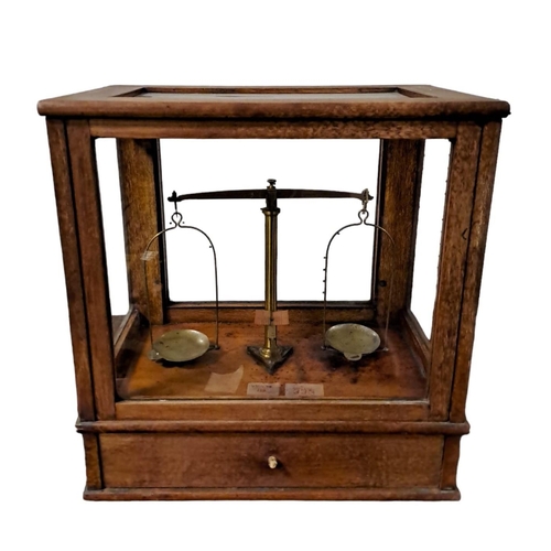 498 - A VINTAGE MAHOGANY AND BRASS CASED LABORATORY SCALES 
35cm (h) x 34cm (w) x 22cm (d)