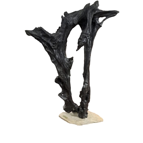 505 - A BOG OAK SCULPTURE of irregular outline on a sandstone base from L.D.H. Studio Clane 
83cm (h) x 37... 