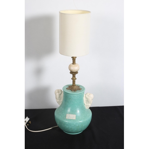 547 - AN ART DECO TABLE LAMP of bulbous outline the turquoise ground with gilt brass and knopped column ab... 