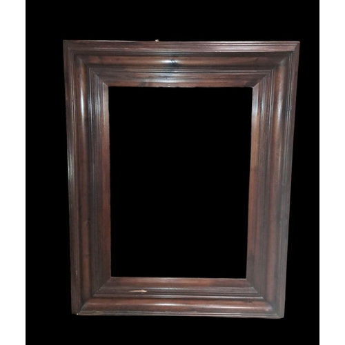 554 - A STAINED BEECHWOOD FRAMED MIRROR the rectangular bevelled glass plate within a moulded frame 
150cm... 