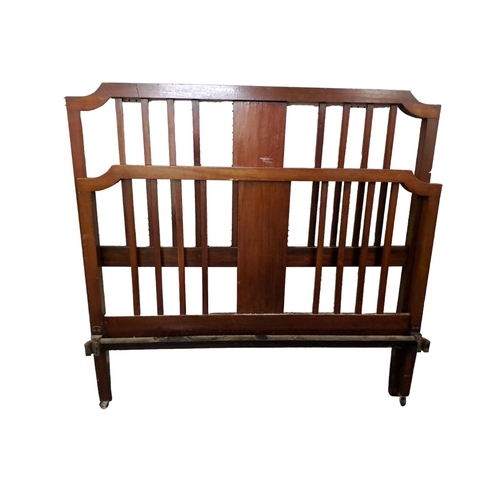 565 - TWIN MAHOGANY VINTAGE BEDS of rectangular arched outline on square moulded legs with castors 
131cm ... 