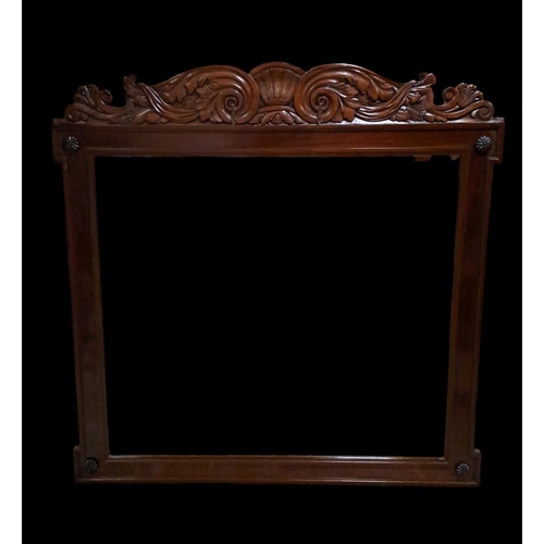 567 - A VICTORIAN STYLE MAHOGANY MIRROR the rectangular bevelled glass plate within a moulded frame with c... 