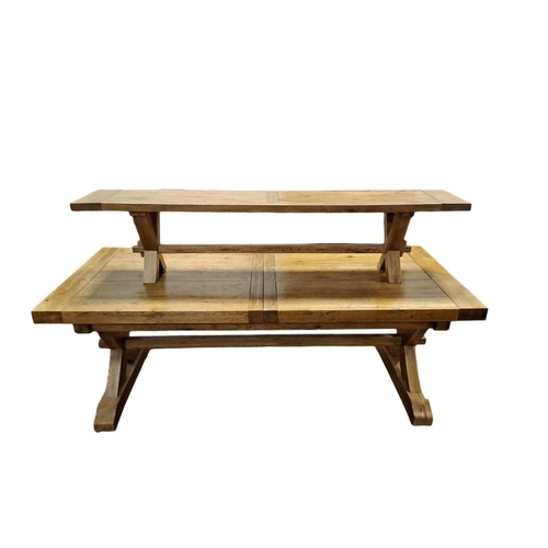 6 - AN OAK REFECTORY TABLE of rectangular outline the shaped plank top on X-shaped supports and platform... 