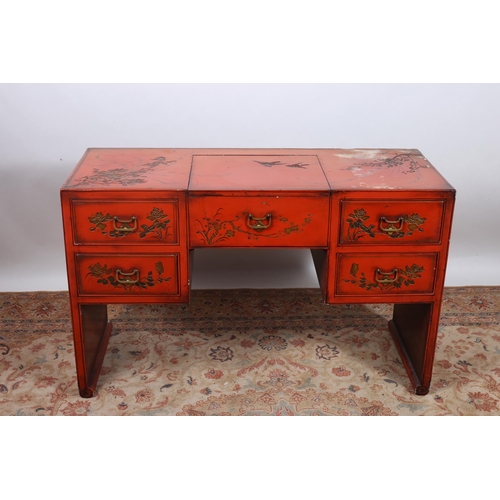 63 - A CHINESE RED LACQUERED DRESSING TABLE of rectangular outline the shaped top centred by a hinged com... 