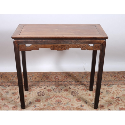 73 - A CHINESE HARDWOOD TABLE of rectangular outline the shaped top with pierced carved frieze on square ... 