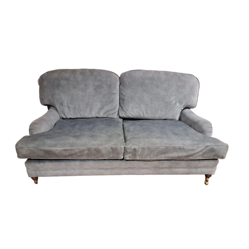 182 - A TWO SEATER SETTEE the rectangular frame with scroll over arms and loose cushions on turned legs wi... 