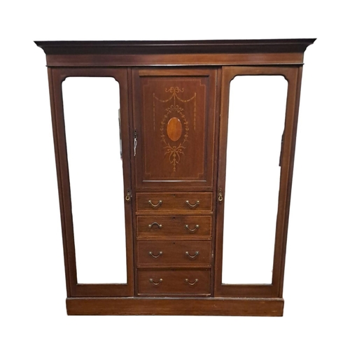 184 - AN EDWARDIAN MAHOGANY INLAID COMBINATION WARDROBE the central section containing a cupboard and four... 