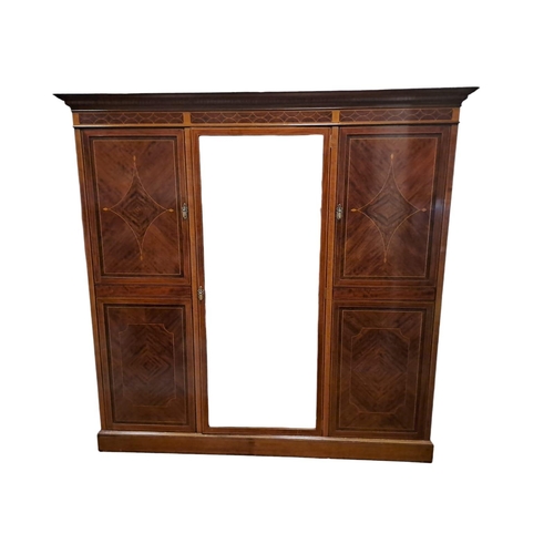 185 - A GOOD EDWARDIAN MAHOGANY AND SATINWOOD INLAID WARDROBE the moulded cornice above a bevelled glazed ... 