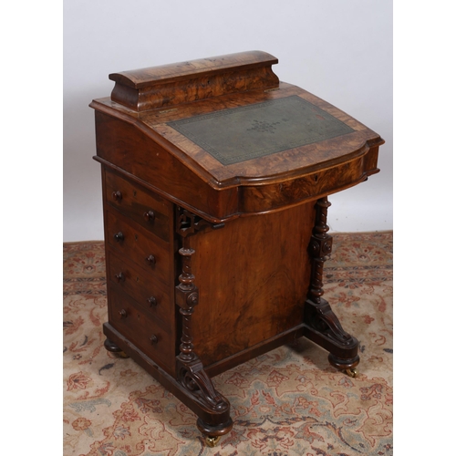 189 - A 19TH CENTURY BURR WALNUT DAVENPORT the superstructure with hinged compartment and tooled leather w... 