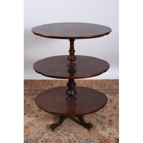 190 - A 19TH CENTURY BURR WALNUT THREE TIER DUMBWAITER of oval shaped outline each shelf joined by a carve... 