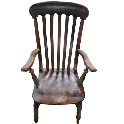 399 - A VINTAGE ELM ELBOW CHAIR the curved top rail with slatted back with shaped seat and moulded arms on... 