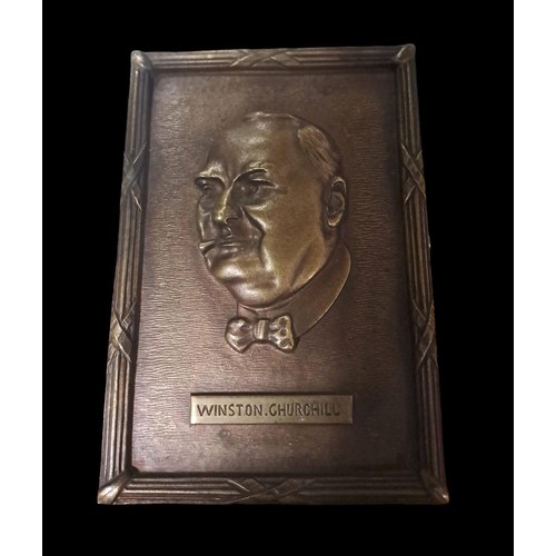 495 - A BRONZE RELIEF PLAQUE depicting Winston Churchill 
17cm (h) x 12cm (w)