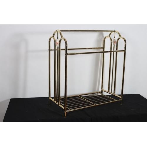 69 - A BRASS AND PORCELAIN TOWEL RAIL of rectangular form the tubular frame joined by an openwork under t... 