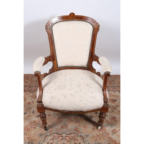 71 - AN EDWARDIAN WALNUT AND MARQUETRY INLAID AND UPHOLSTERED ARMCHAIR the shaped top rail above an uphol... 