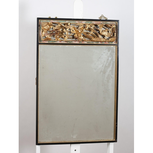 154 - AN ORIENTAL EBONISED AND GILT MIRROR the rectangular plate with flowerhead and foliate pierced crest... 