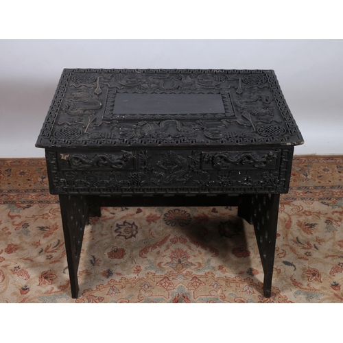 237 - A 19TH CENTURY ORIENTAL EBONISED CARVED FOLDING TRAVELLING SCRIBES TABLE of rectangular outline carv... 