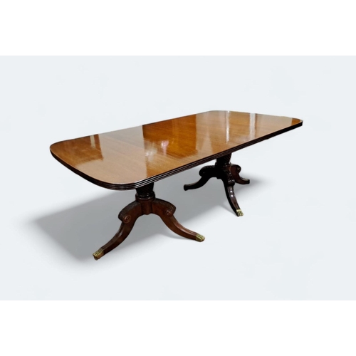 244 - A GEORGIAN STYLE MAHOGANY DINING TABLE of rectangular outline with rounded ends and reeded rim with ... 