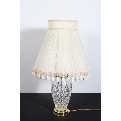 286 - A WATERFORD CUT GLASS TABLE LAMP of urn form on gilt spreading foot with pleated shade 
60cm (h)